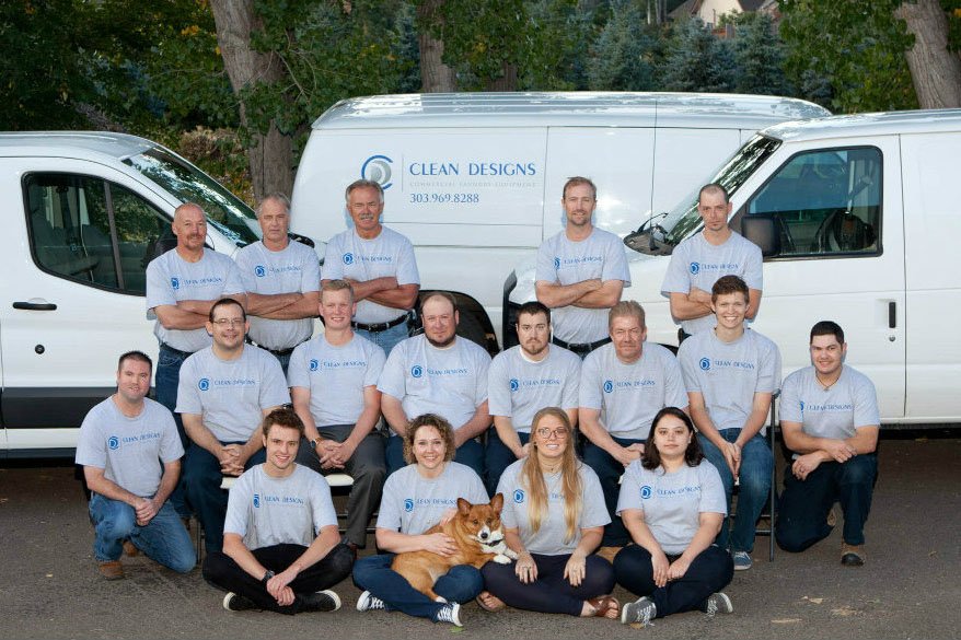 Clean Designs Staff in front of service vans.